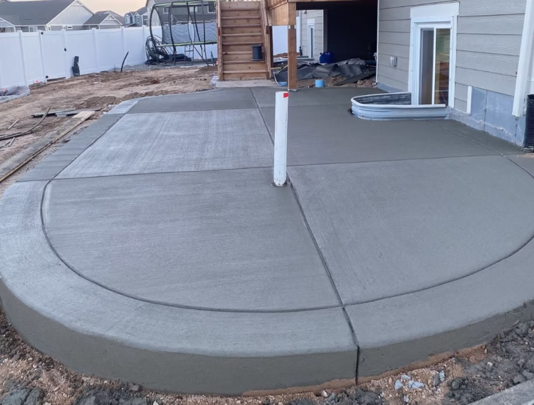 Newly installed concrete patio in Loveland, CO, with a smooth and broom finish, built for durability and style
