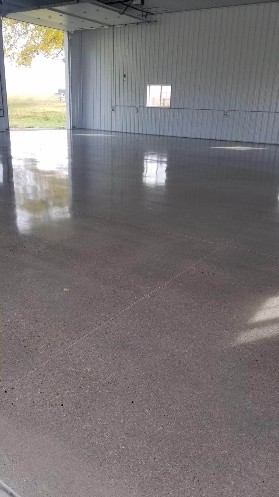 Polished concrete flooring in a spacious indoor area, showcasing a smooth, reflective surface in Windsor, CO