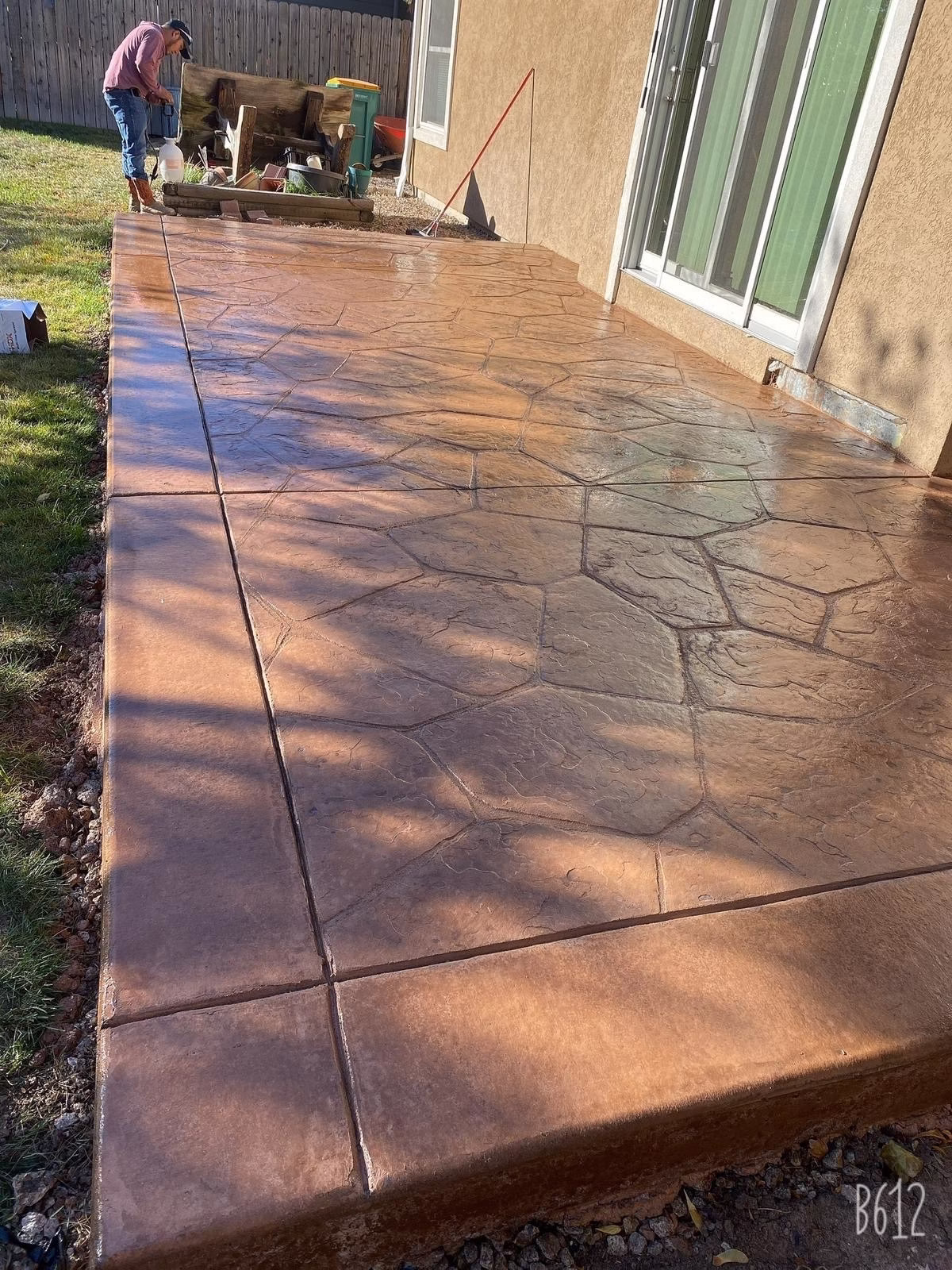 Custom-designed colored concrete patio in a Greeley, CO, backyard, featuring a decorative and durable finish