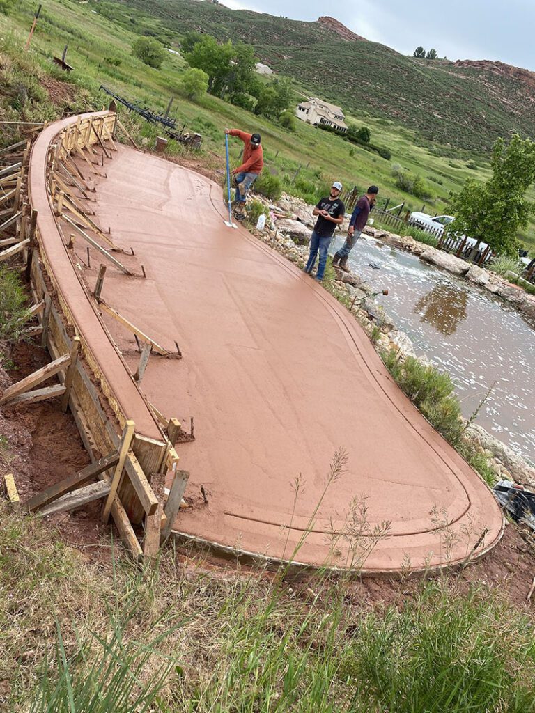 Curved colored concrete patio installed in Loveland by Hugo’s Concrete