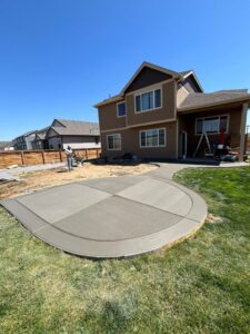 Finished concrete patio and walkway installed on 67th Ave in Greeley, Colorado, featuring clean lines and a modern layout