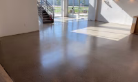 Spacious interior of a commercial property in Colorado featuring a polished concrete floor with a smooth, glossy finish, enhancing the modern aesthetic under natural light.