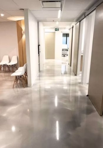 Commercial epoxy coating installation at building in Berthoud, Colorado by Hugo's Concrete, featuring a stunning coated surface