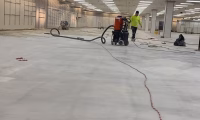 Concrete floor polishing process in progress at a large commercial space. Comparison of Concrete Polishing vs. Epoxy Coating for durable and low-maintenance flooring.