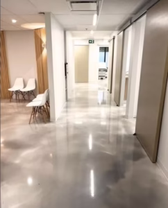 Commercial epoxy coating installation at building in Berthoud, Colorado by Hugo's Concrete, featuring a stunning coated surface