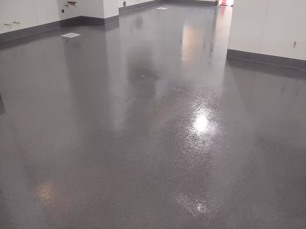 High-gloss epoxy flooring installed in Fort Collins by Hugo’s Concrete, providing a durable and modern finish for long-lasting performance.