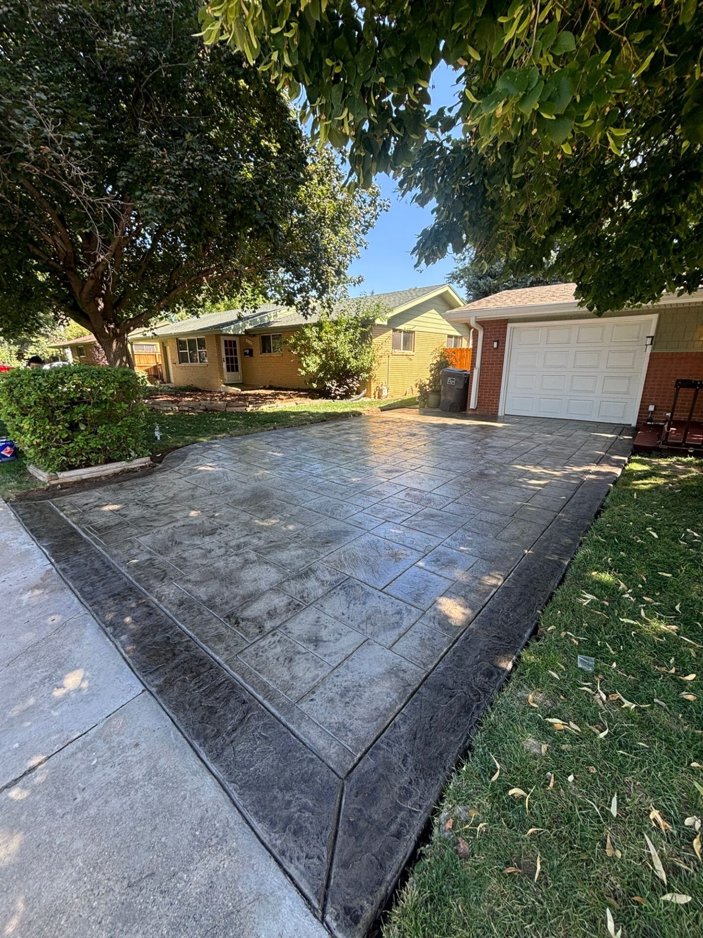 "New concrete driveway installation in Loveland, CO – smooth and durable residential driveway by Hugo’s Concrete Polishing."