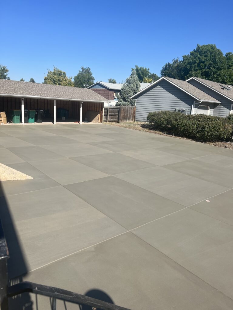 Freshly installed concrete driveway in Windsor, CO, with a smooth and durable finish