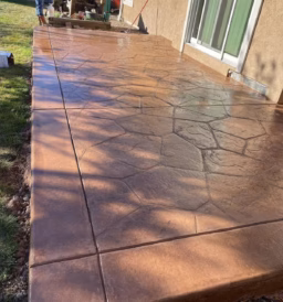 Custom-designed colored concrete patio in a Greeley, CO, backyard, featuring a decorative and durable finish